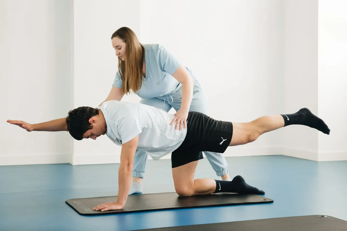 Begleitete Übung auf einer Matte im Therapieraum